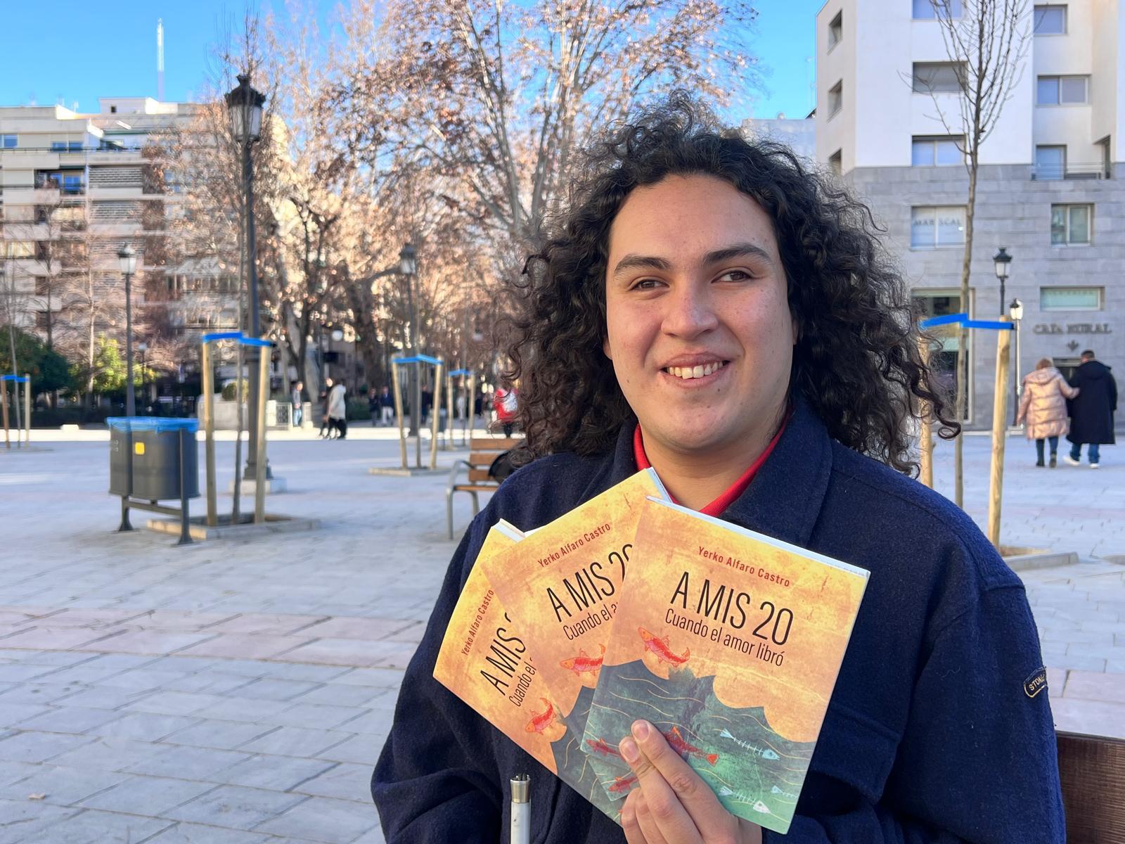 Yerko posa con tres ejemplares de su libro